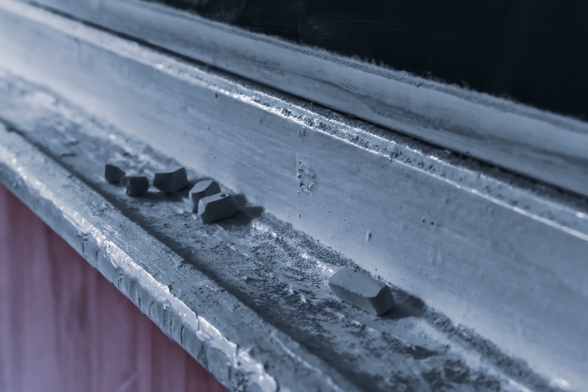 Chalk on the weathered shelf of a blackboard. Photograph by Diana, via Pexels.